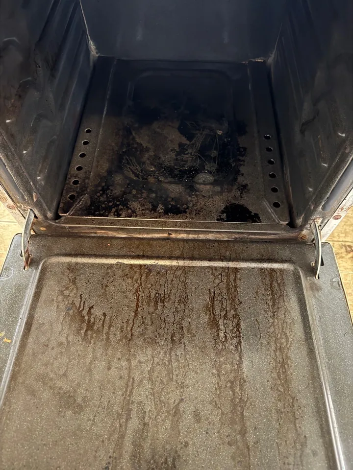 Same oven interior before a Swept Up move-out clean