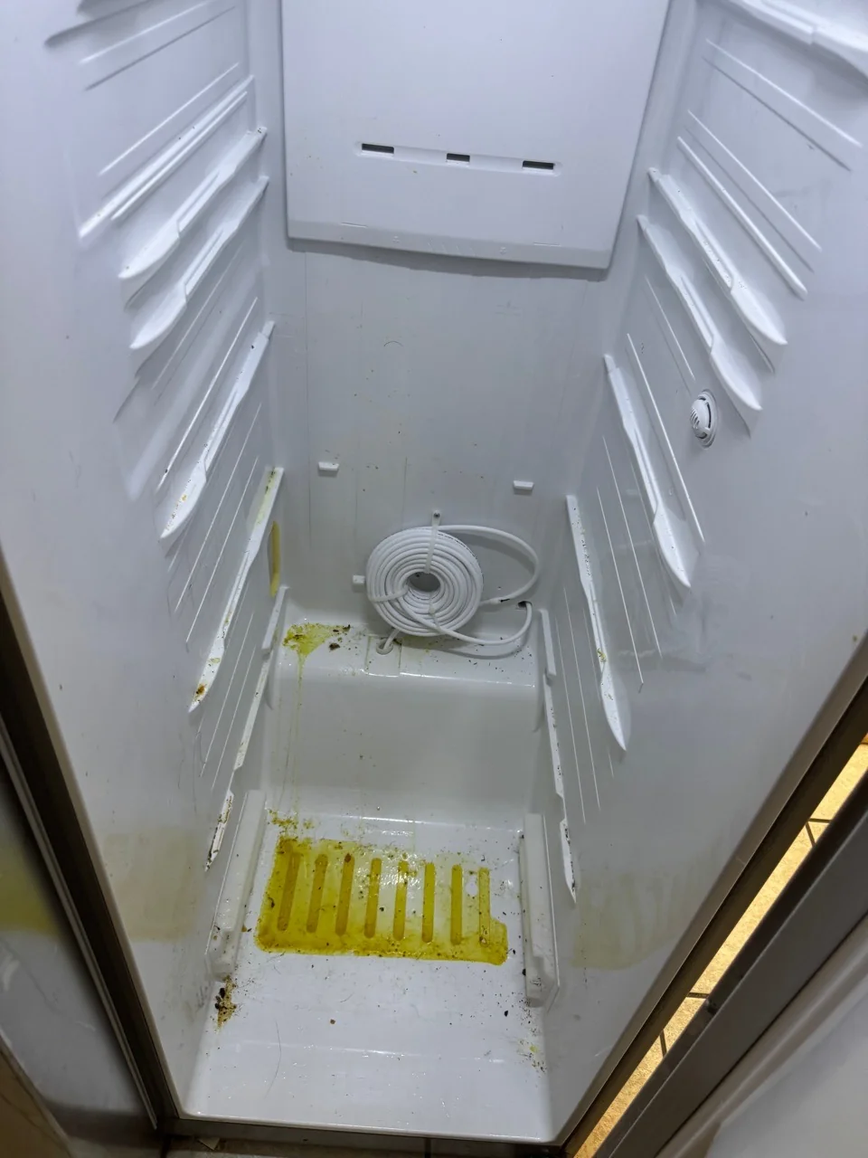 Same fridge interior before a Swept Up move-out clean