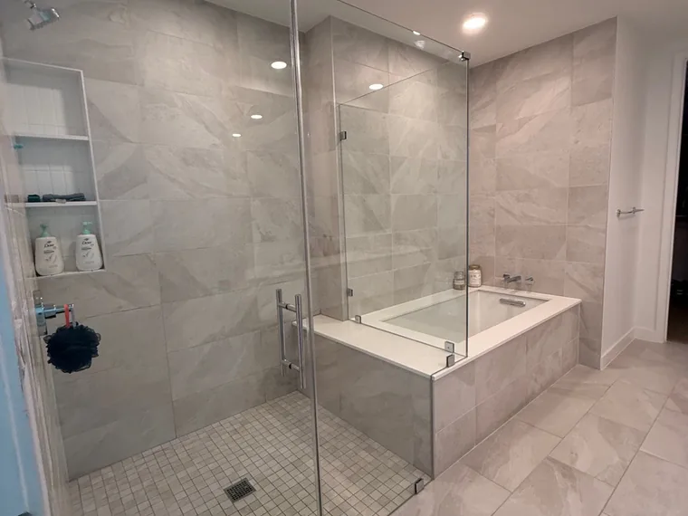 New-build marble bathroom with glass shower, dust-free